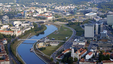 A fine view of the city with the Neris River gleaming in the distance.