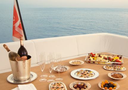 Fruit, snacks and wine on a table on the upper deck.